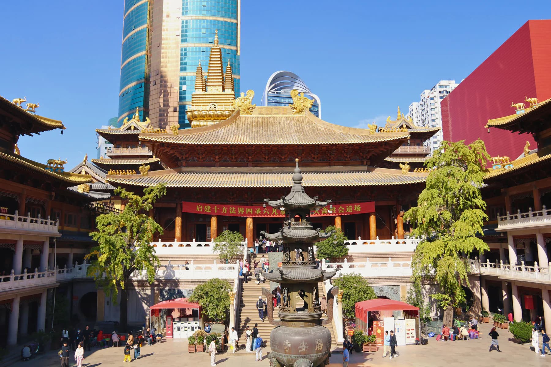 A historic Shanghai temple courtyard surrounded by contemporary city buildings