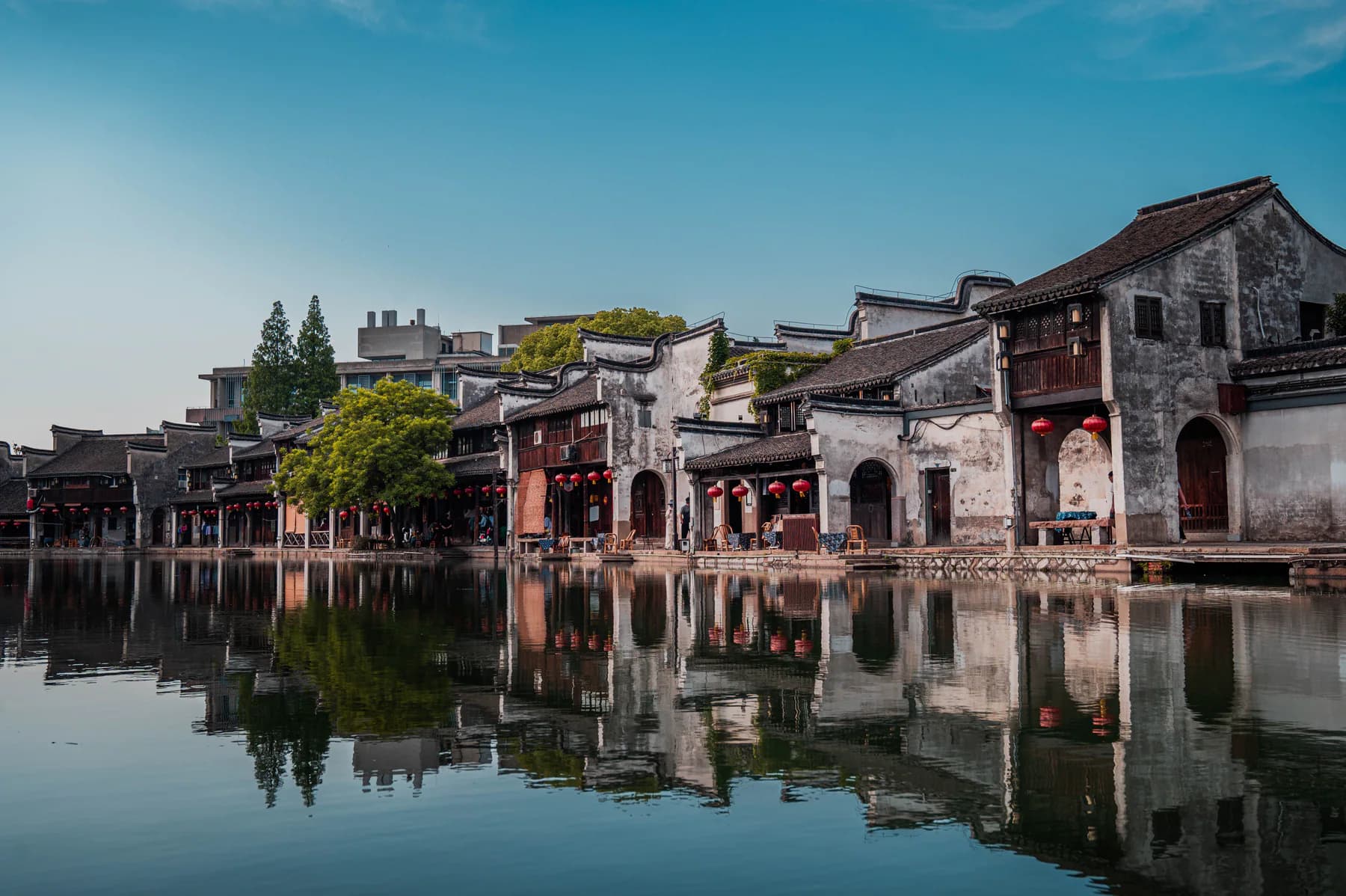 Historic houses reflected in a calm Suzhou waterway