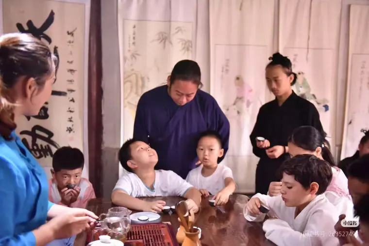 Participants sharing a cultural session around a tea table